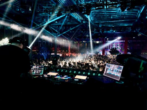 Nachtclub mit tanzenden Menschen, bunten Lichtern und einer lebhaften Atmosphäre.